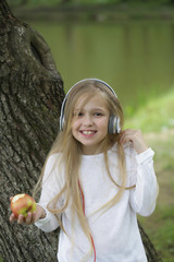 small girl in music hearphone