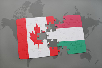 puzzle with the national flag of canada and hungary on a world map background.