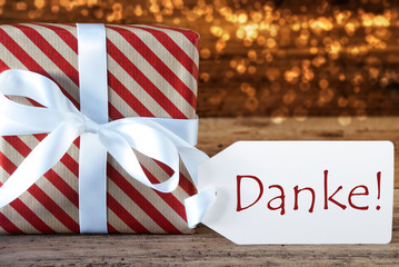 Fototapeta na wymiar Atmospheric Christmas Gift With Label, Danke Means Thank You