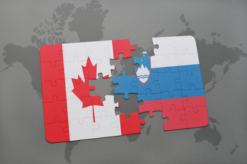 puzzle with the national flag of canada and slovenia on a world map background.