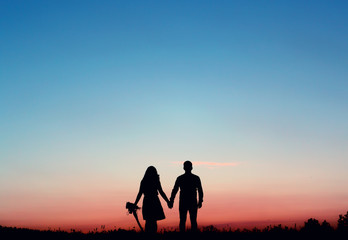 Fototapeta na wymiar Silhouetted loving couple at sunset