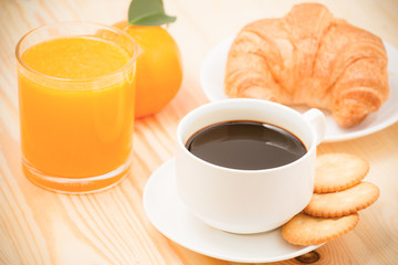 Delicious continental breakfast with fresh flaky croissants, assorted preserves, orange juice