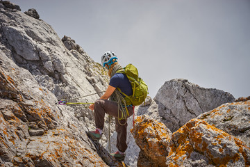 woman climbing in mountains of Austria / Extreme Sports in the Alps