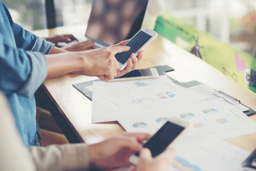 Young businesswoman hard at work at her desk writing notes on a