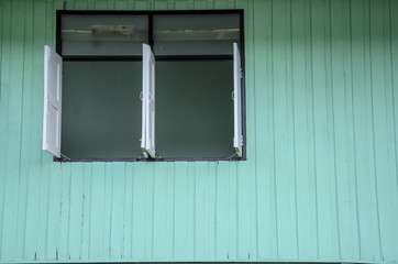 Obraz na płótnie Canvas Windows with green wooden wall