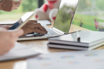 Close up of a druggist making notes from the laptop