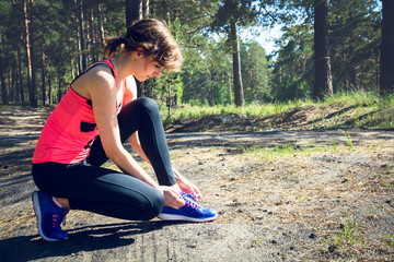 Running shoes. Closeup of woman tying shoe laces. Female sport f