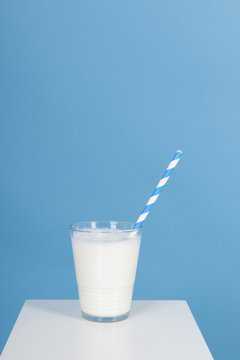 Glas of milk on blue