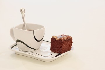 Cup of tea with  brownie cake on a white background.
