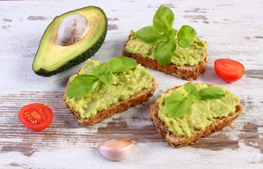 Freshly sandwiches with paste of avocado and ingredients, healthy food and nutrition