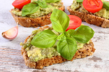 Freshly sandwiches with paste of avocado and ingredients, healthy food and nutrition