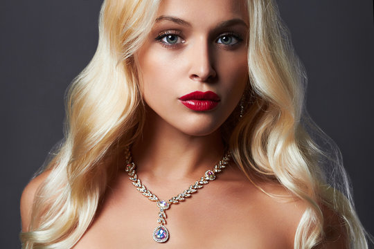 luxury beautiful young woman with healthy curl blond hair. girl with make-up and jewelry