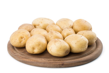 Young potatoes on a cutting board on white background close-up.