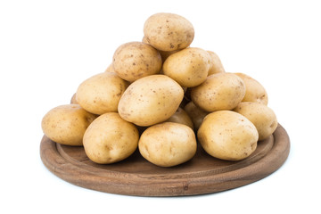 Young potatoes on a cutting board on white background close-up.