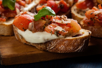 Italian bruschetta with roasted tomatoes, mozzarella cheese and
