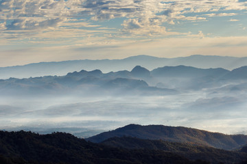 Fototapeta na wymiar Layer of mountains and mist at sunrise time, Landscape at Doi Luang Chiang Dao, High mountain in Chiang Mai Province, Thailand