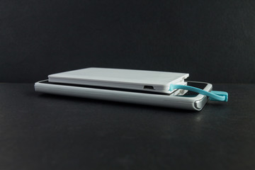 Smartphone charging with power bank on black  background © Baikal360