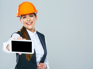 Smiling builder business woman showing tablet PC with yours info