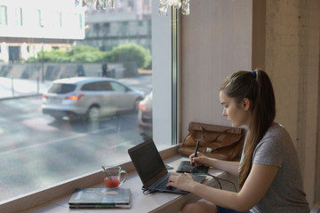 Young woman working in a cafe
