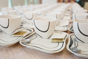 Preparing the new sets of coffee cup for conference breaking time.