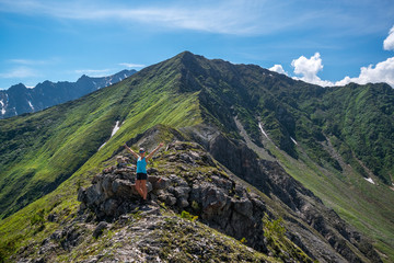 Fototapeta premium girl standing at the top of the pass Arshansky