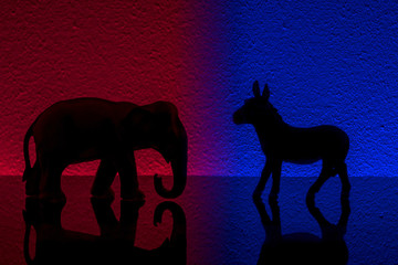 Democrats vs republicans are facing off in a ideological duel on blue and red backgrounds. In...