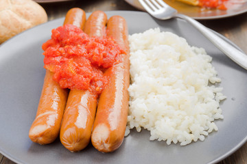 whole frankfurters, stewed with rice and tomato