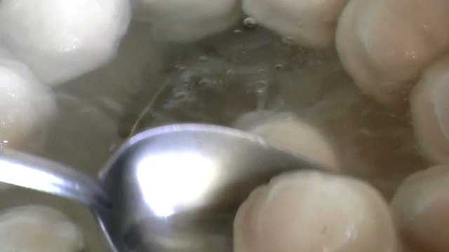 The video shows dumplings in boiling water