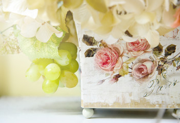 Colorful decoration artificial flower in decoupage wooden tree box, vintage style (soft focus)