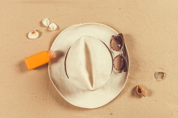 Summer hat put on the tropical sand beach