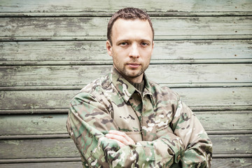 Young military man in camouflage uniform