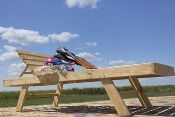 Chaise lounge by the pool .