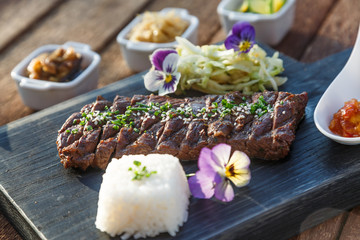 Beef steak grilled in korean style with kimchi and marinated vegetables