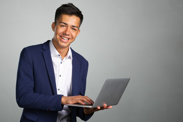 Portrait of smiling young man with laptop