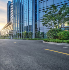 Fototapeta premium city empty traffic road with cityscape in background