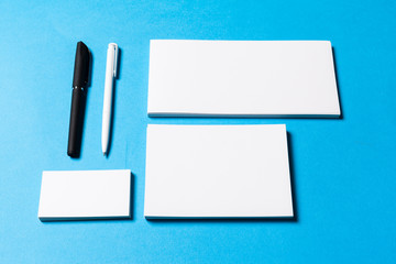 blank office objects organized for company presentation on blue paper background