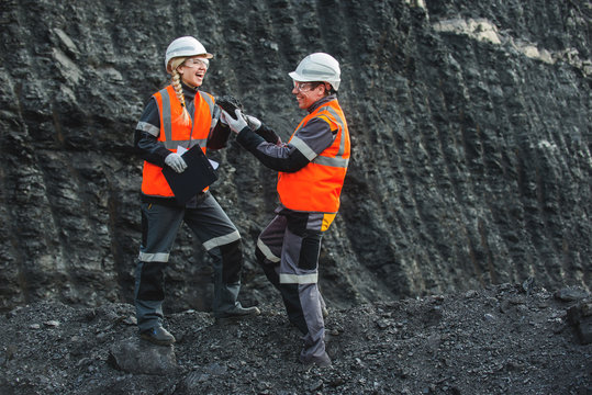 Workers with coal at open pit