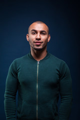 Portrait of an african american man smiling on dark blue background