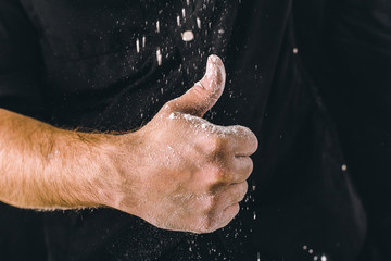 Naklejka na ściany i meble adult man hands work with flour, dark photo
