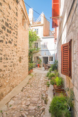 Fototapeta na wymiar Narrow street and old houses in old town in Cres, Croatia, Mediterranean ambient