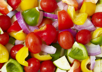 A full page close up of fresh prepared Mediterranean vegetables forming a background texture