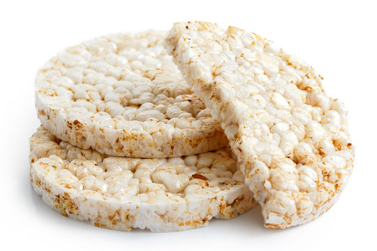Pile of two and half puffed rice cakes isolated on white.