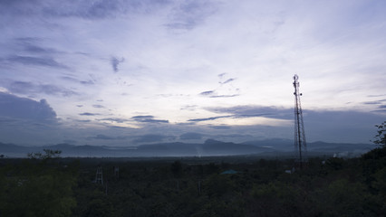 mountain hill and communication tower before sunset