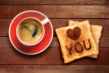 Breakfast, coffee and toast with a heart pattern, on a wood background
