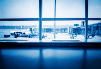 Airplanes On Airport Runway Seen Through Glass Window