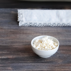 Cottage cheese (dairy product) on a wooden table 