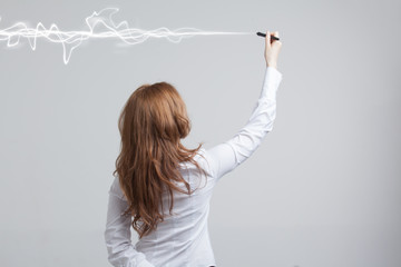 Woman making magic effect - flash lightning. The concept of electricity, high energy.
