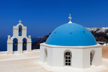 Fototapeta na wymiar The Three bells of Fira and blue dome, Santorini, Greece.
