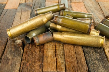 Obraz na płótnie Canvas Bullets shell on wooden background. Stock image macro.