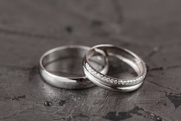 Silver wedding ring on black background